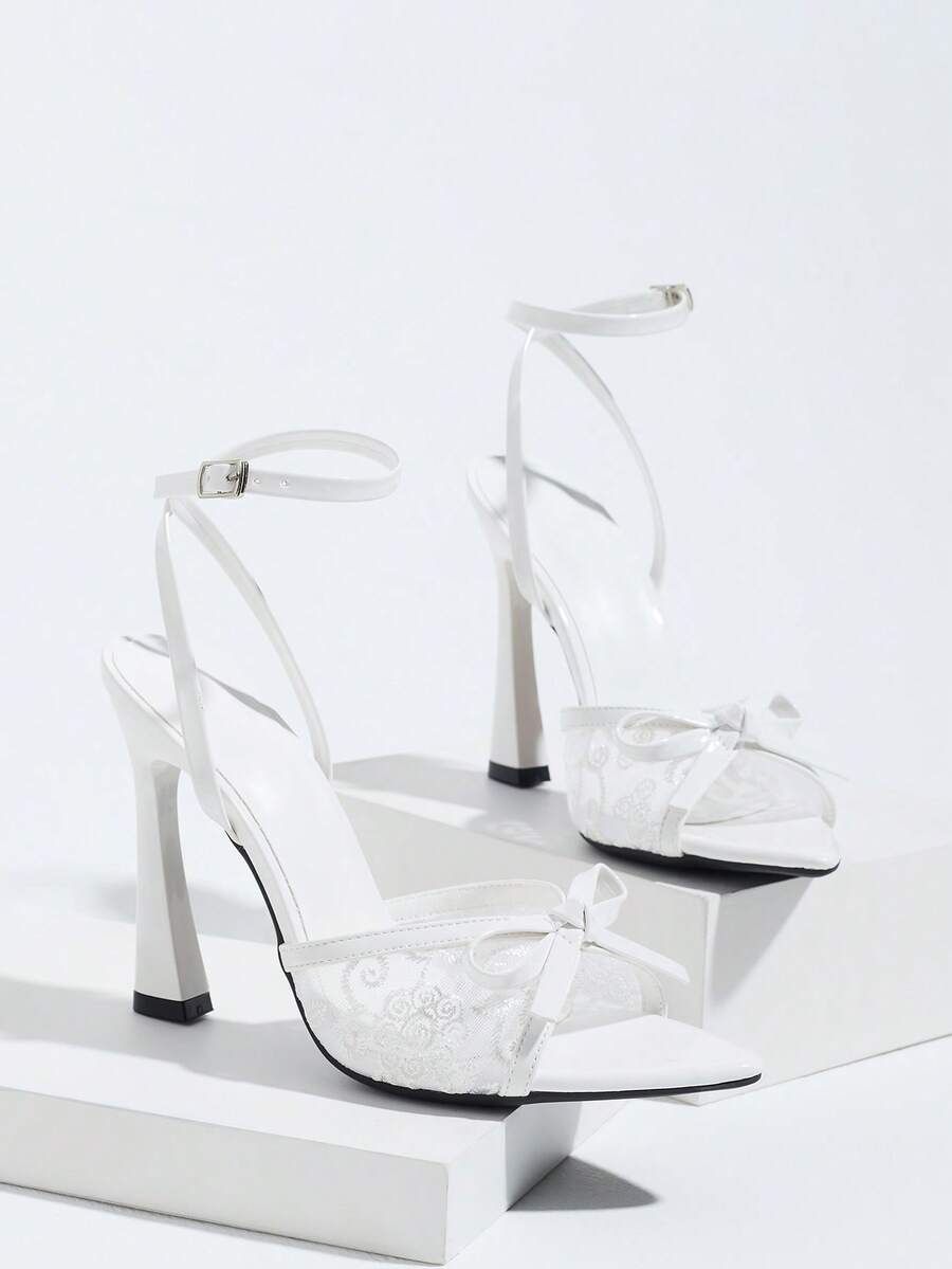 Burgundy open-toe high heels featuring an adjustable ankle strap with buckle closure and high stiletto heel.