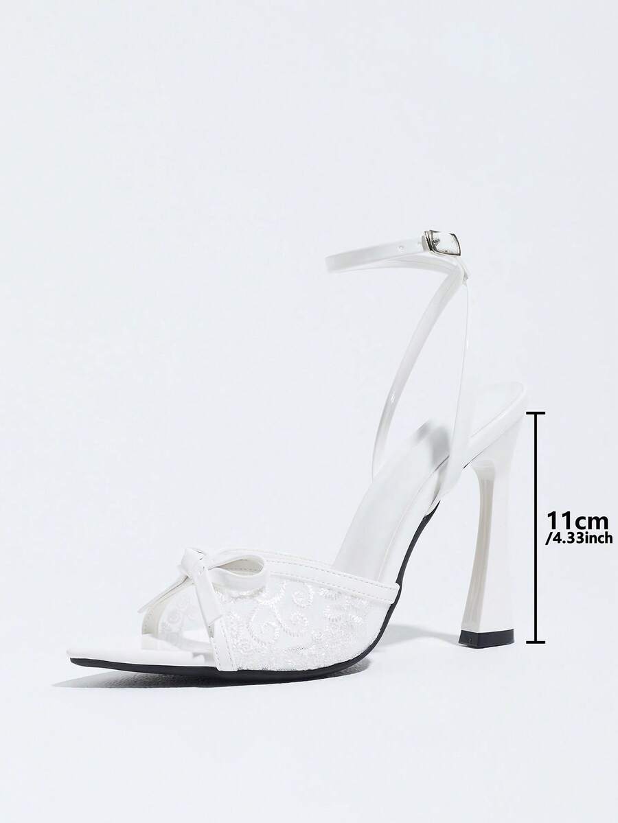 Burgundy open-toe high heels featuring an adjustable ankle strap with buckle closure and high stiletto heel.