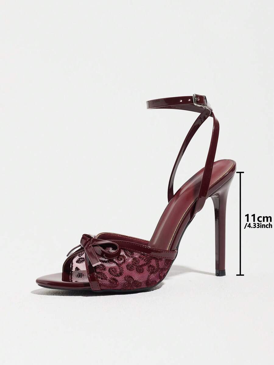 Burgundy open-toe high heels featuring an adjustable ankle strap with buckle closure and high stiletto heel.