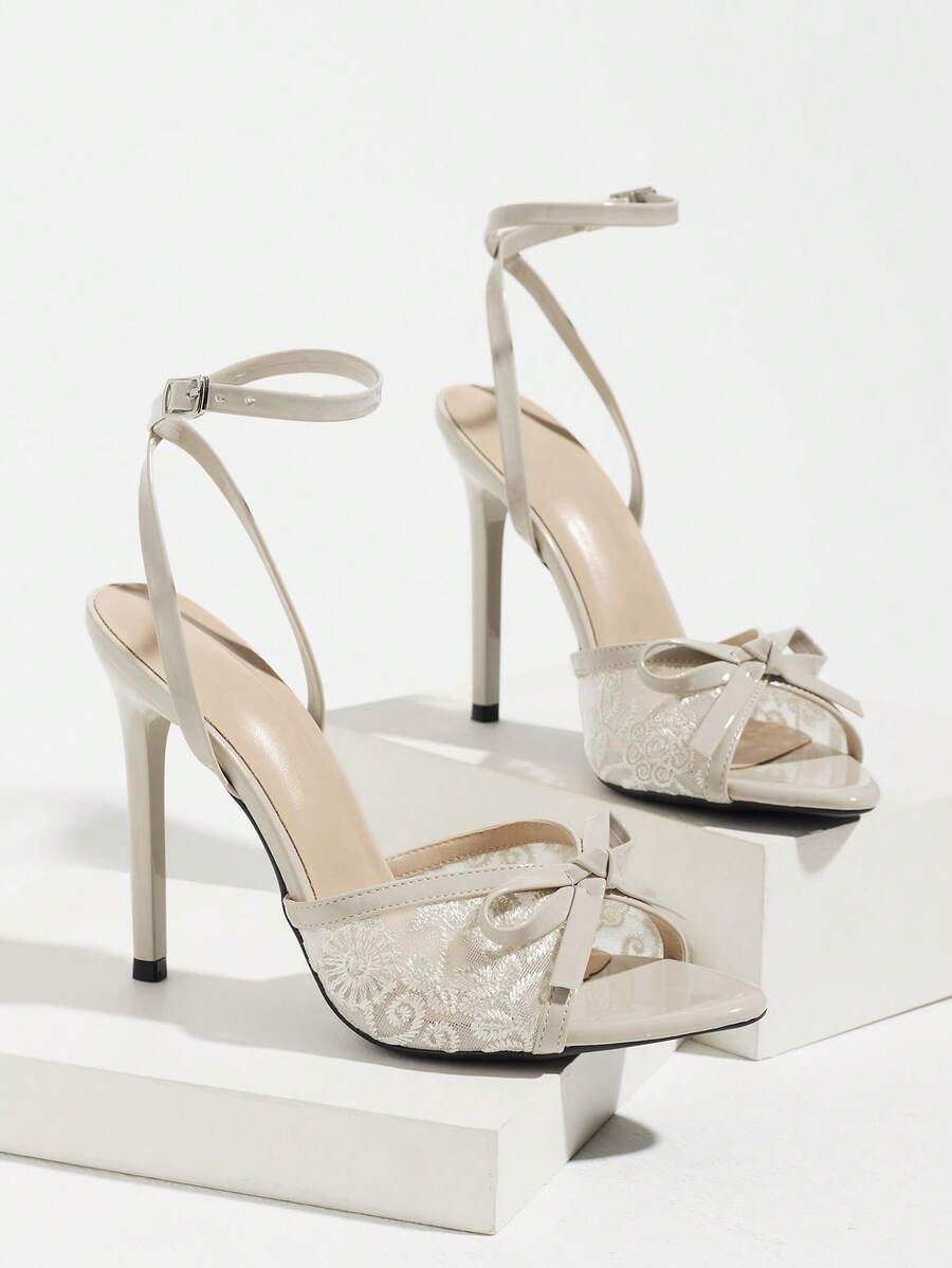 Burgundy open-toe high heels featuring an adjustable ankle strap with buckle closure and high stiletto heel.