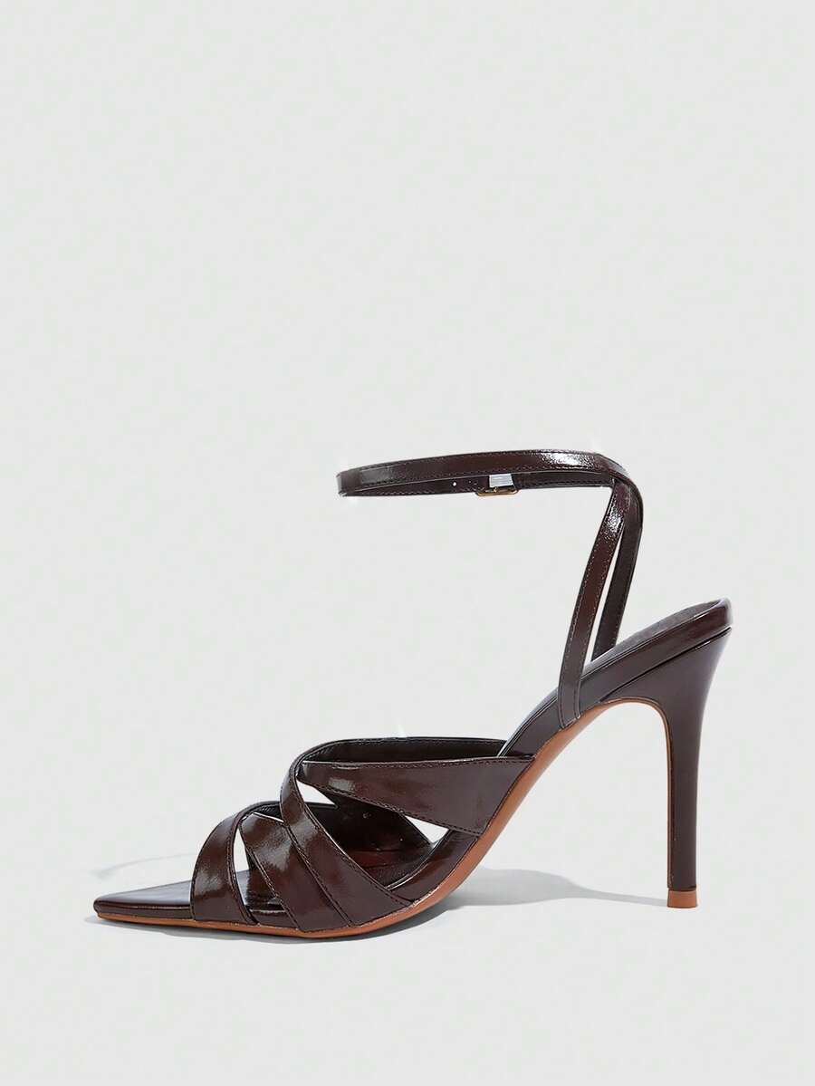 Women's open toe high stiletto sandals with cut-out cross straps and adjustable ankle buckle closure.