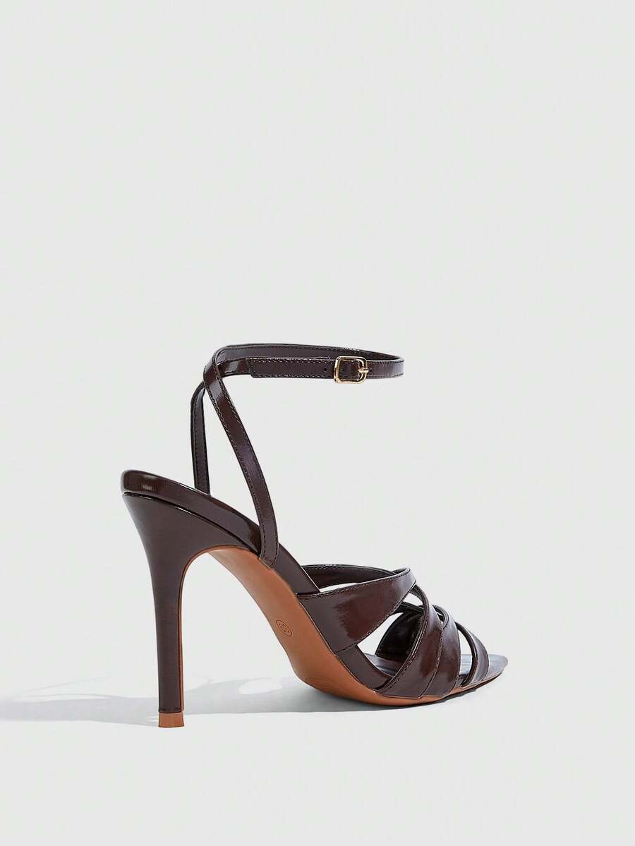 Women's open toe high stiletto sandals with cut-out cross straps and adjustable ankle buckle closure.