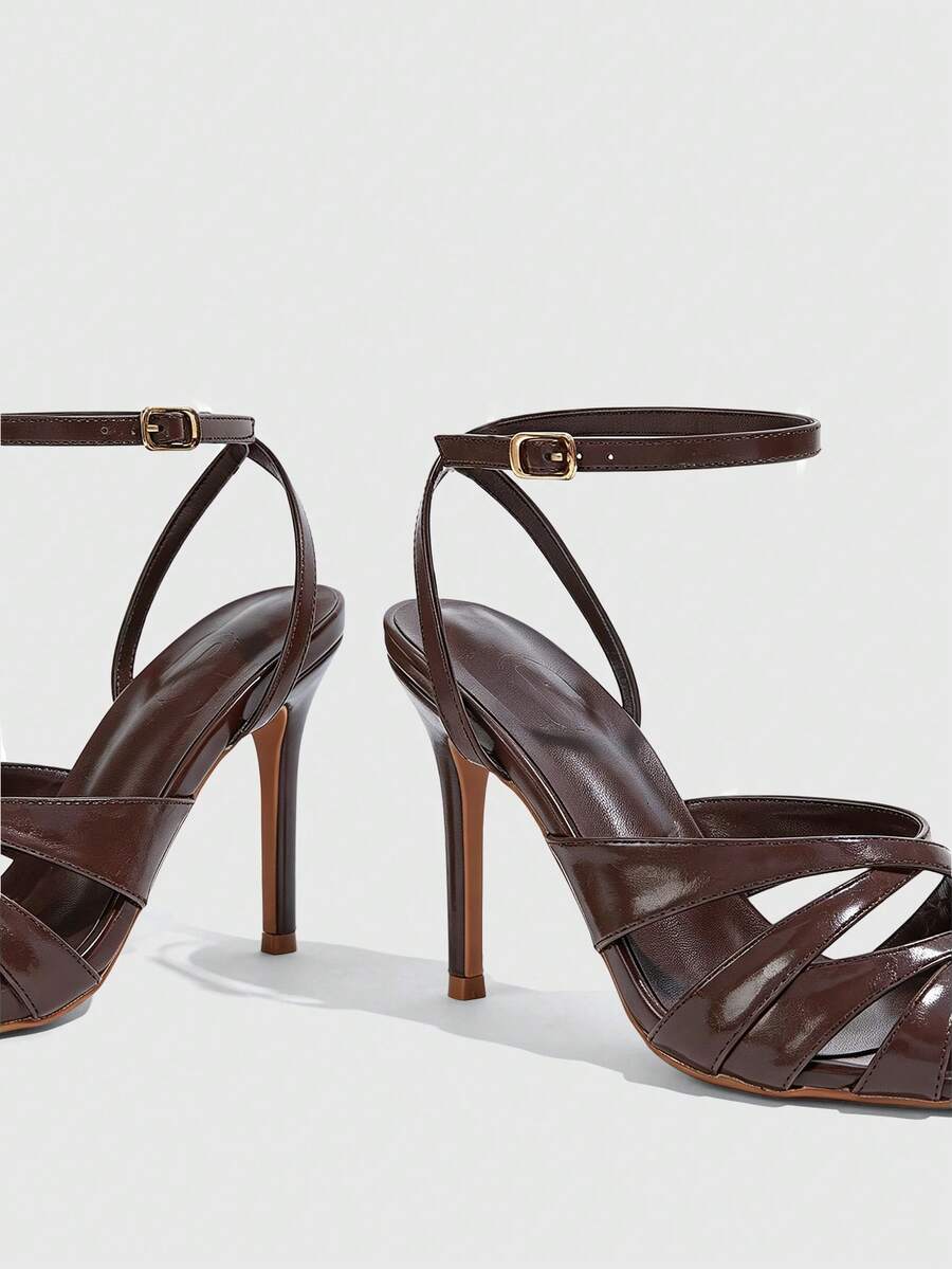 Women's open toe high stiletto sandals with cut-out cross straps and adjustable ankle buckle closure.