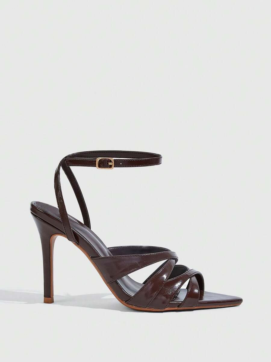 Women's open toe high stiletto sandals with cut-out cross straps and adjustable ankle buckle closure.