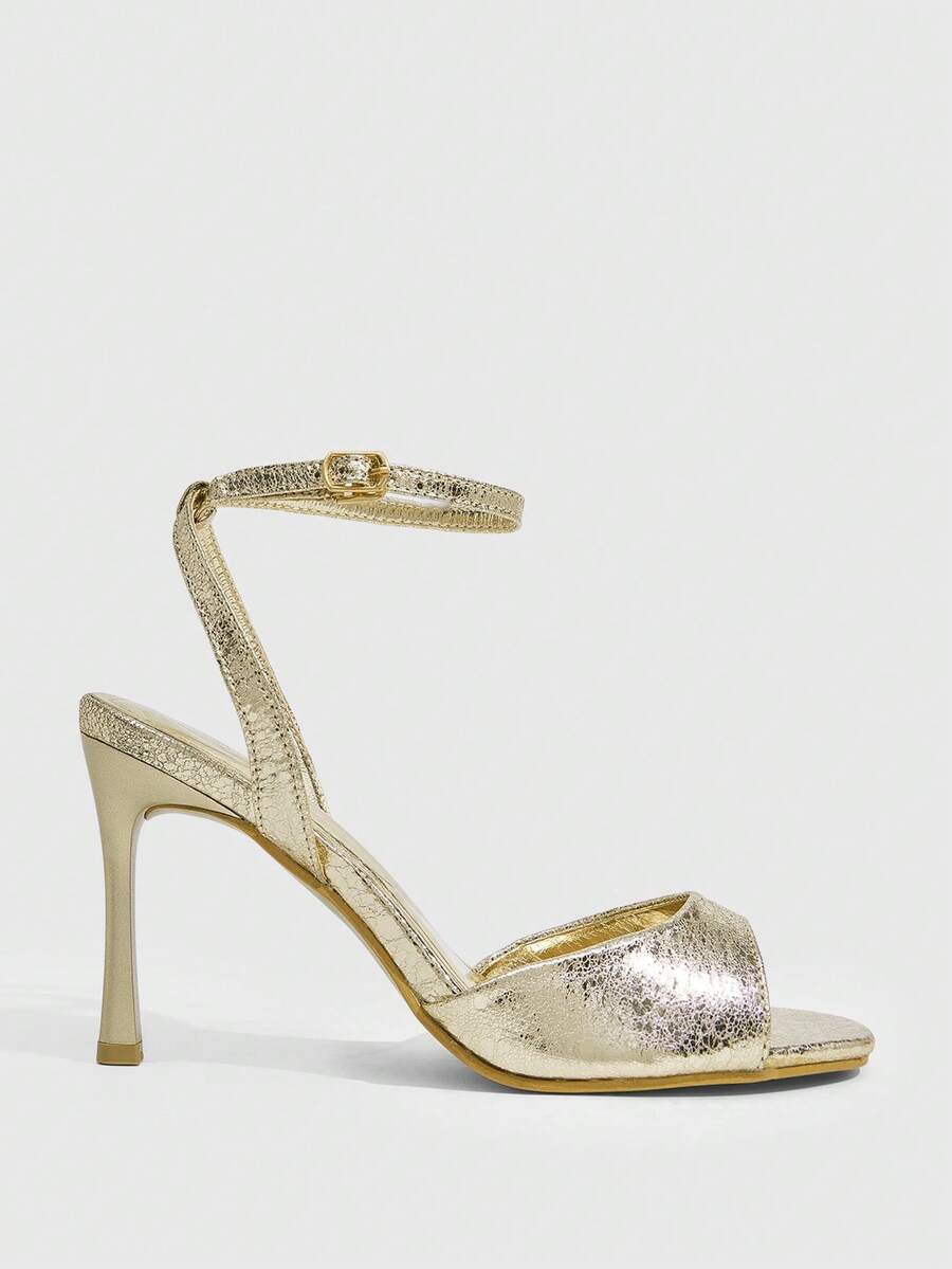 Women's pointed peep toe high heel stilettos featuring cross ankle strap with buckle in black PU leather.