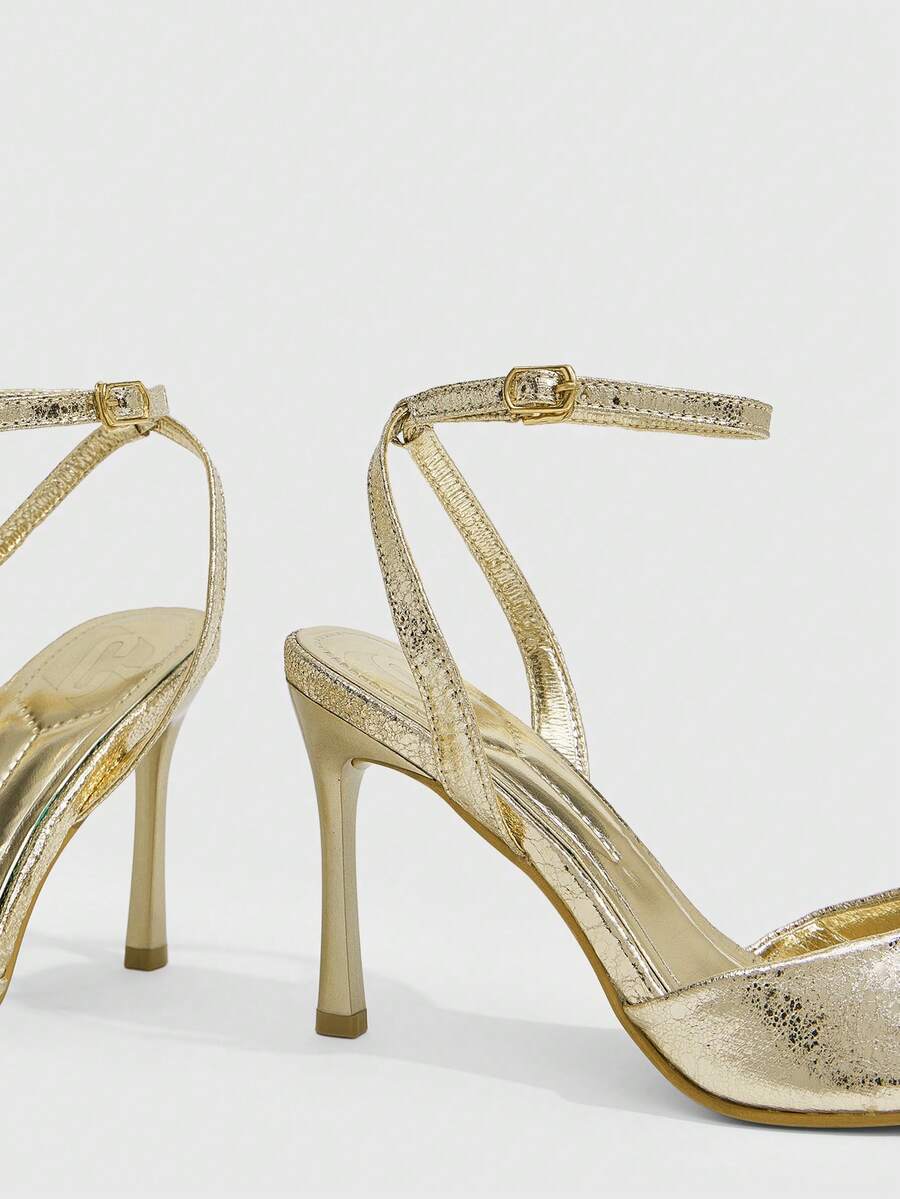 Women's pointed peep toe high heel stilettos featuring cross ankle strap with buckle in black PU leather.