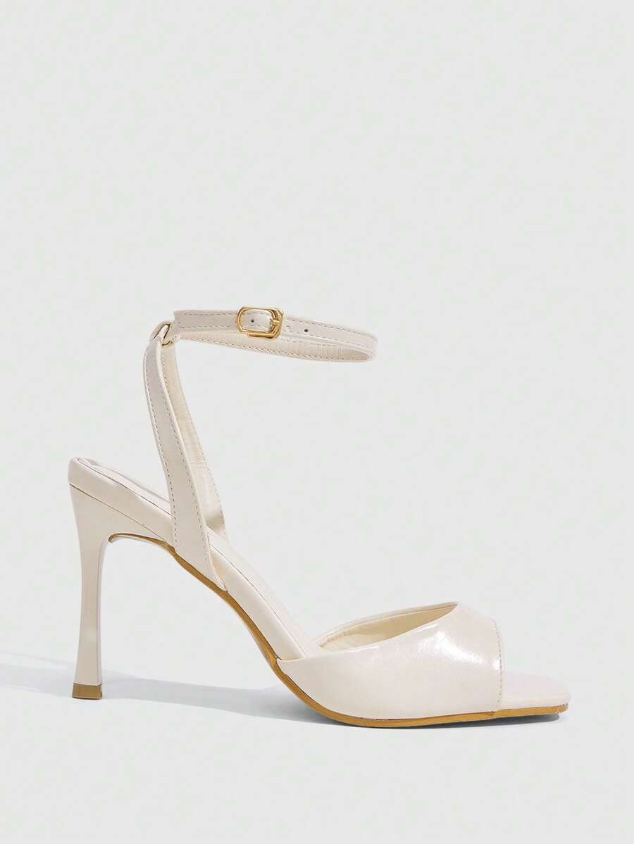 Women's pointed peep toe high heel stilettos featuring cross ankle strap with buckle in black PU leather.