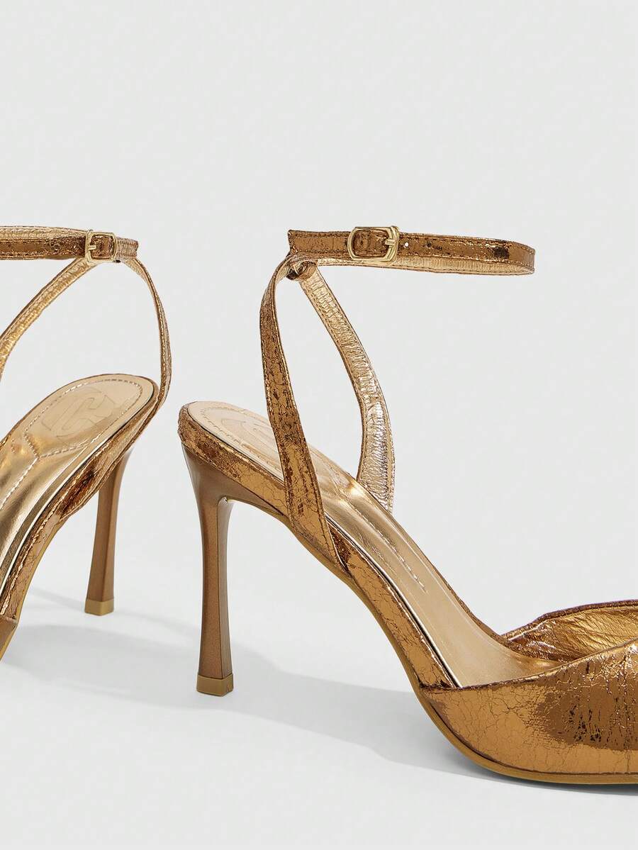 Women's pointed peep toe high heel stilettos featuring cross ankle strap with buckle in black PU leather.