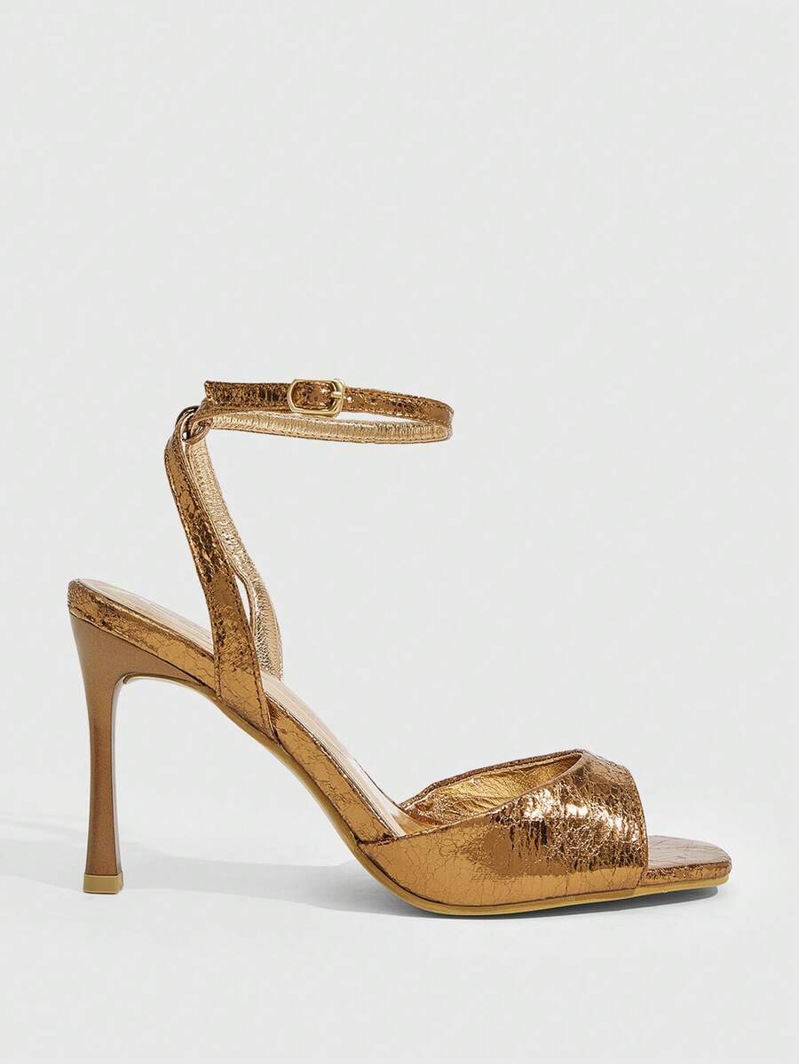 Women's pointed peep toe high heel stilettos featuring cross ankle strap with buckle in black PU leather.