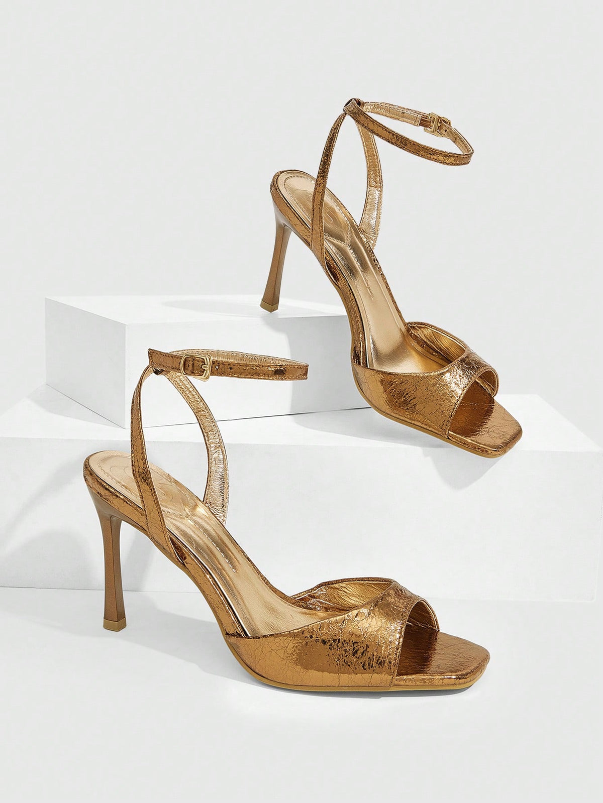 Women's pointed peep toe high heel stilettos featuring cross ankle strap with buckle in black PU leather.