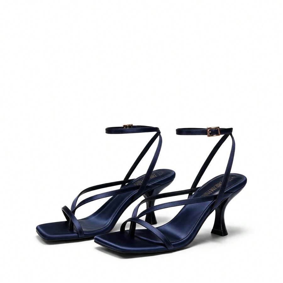 Pair of women's minimalist square toe kitten heeled thong sandals featuring slim ankle straps with buckle closure and sleek low heels.