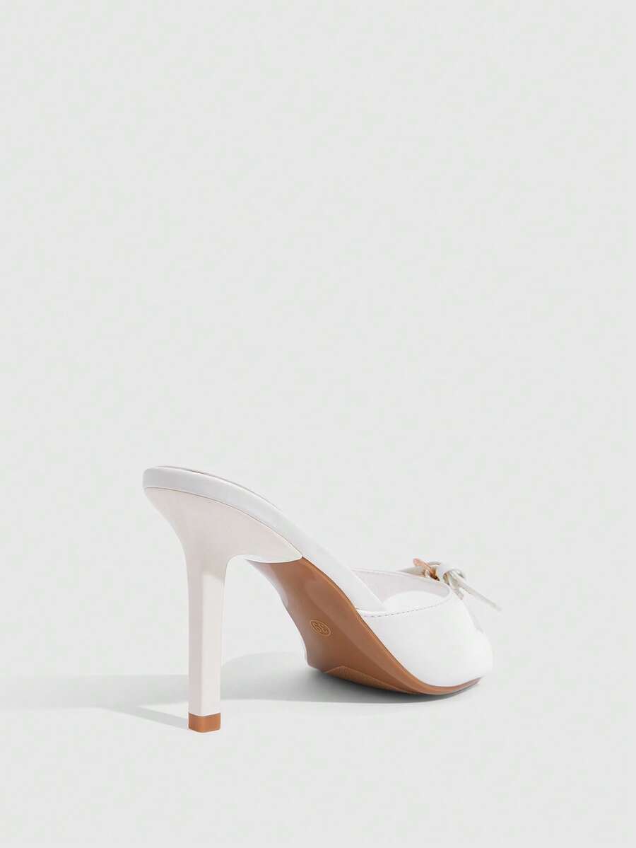 Elegant burgundy high heel slingback sandals with an open toe and round buckle strap.