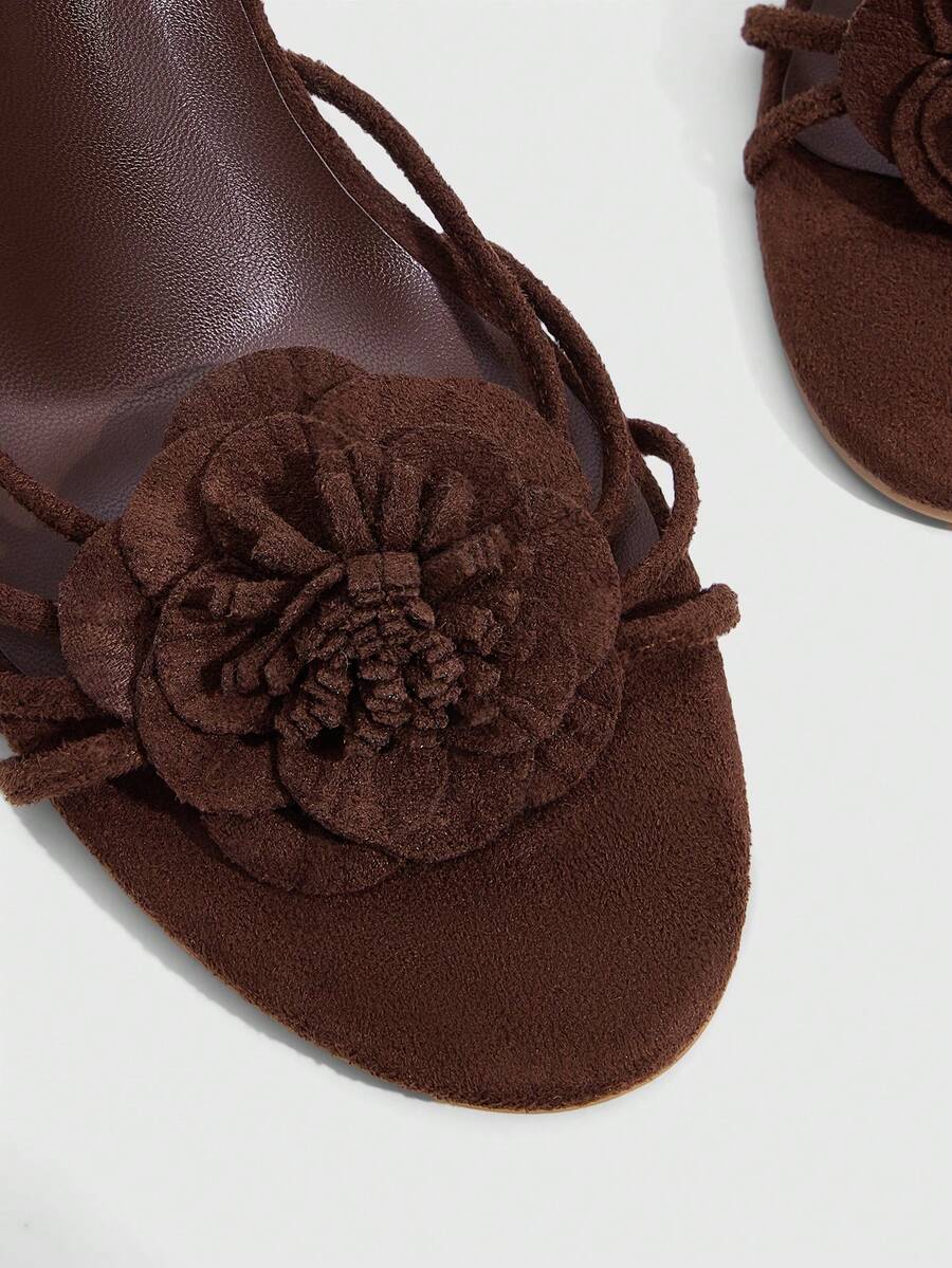Women's round toe high heel sandals with brown flannel finish, floral trim detail, and strappy lace-up stiletto design.