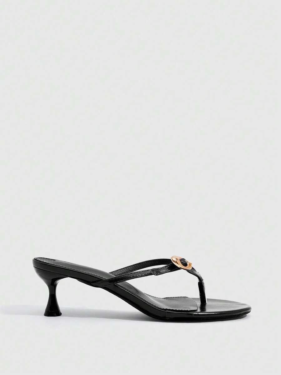 Women's slingback heeled sandals featuring a button toe post accent, sleek mid pyramid heel, and smooth faux leather finish.
