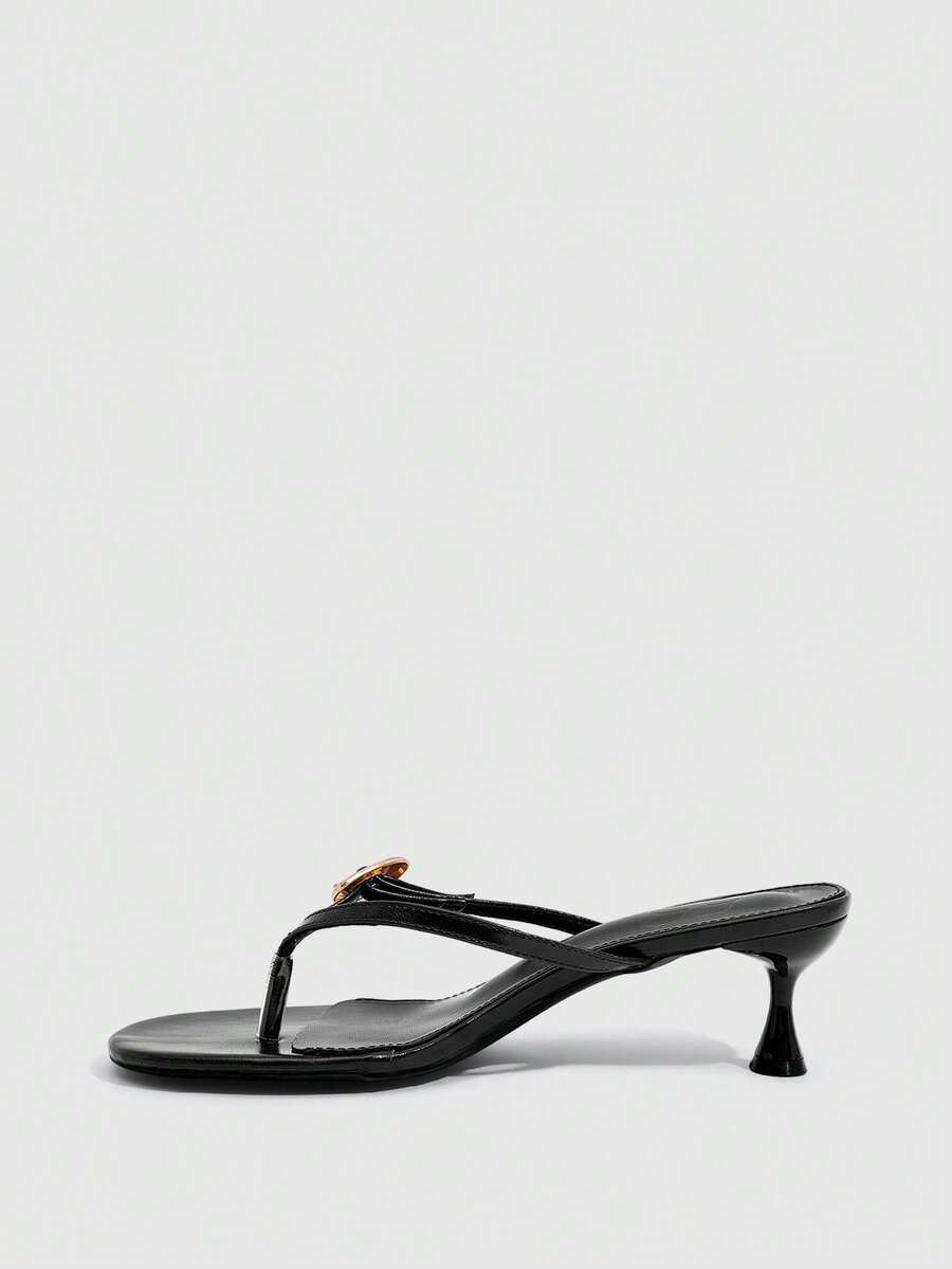 Women's slingback heeled sandals featuring a button toe post accent, sleek mid pyramid heel, and smooth faux leather finish.