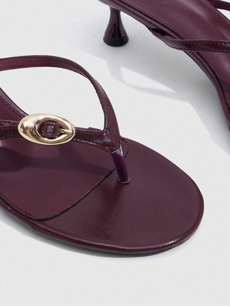 Women's slingback heeled sandals featuring a button toe post accent, sleek mid pyramid heel, and smooth faux leather finish.
