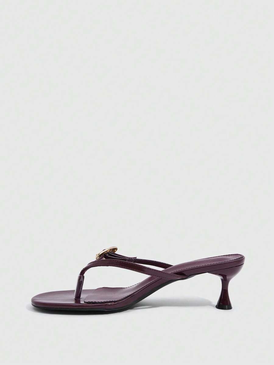 Women's slingback heeled sandals featuring a button toe post accent, sleek mid pyramid heel, and smooth faux leather finish.