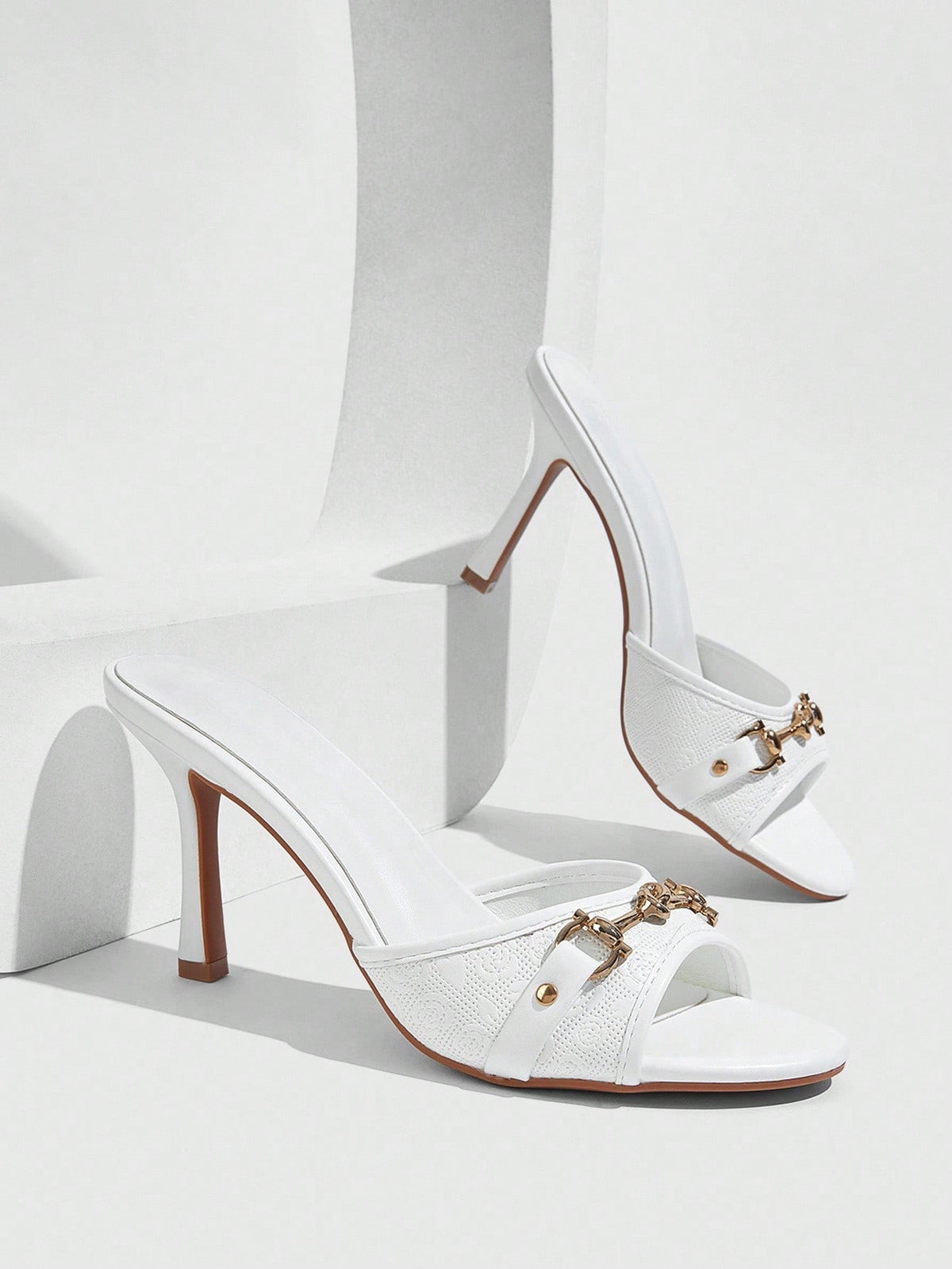 Women's beige high heel mule sandals with open round toe and metal chain detail