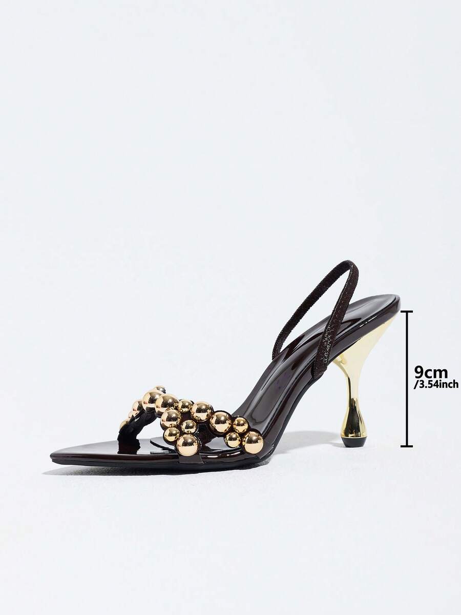 Pointed toe party high heels in gold featuring wavy lace trim, a stiletto heel, and back tie slingback straps.