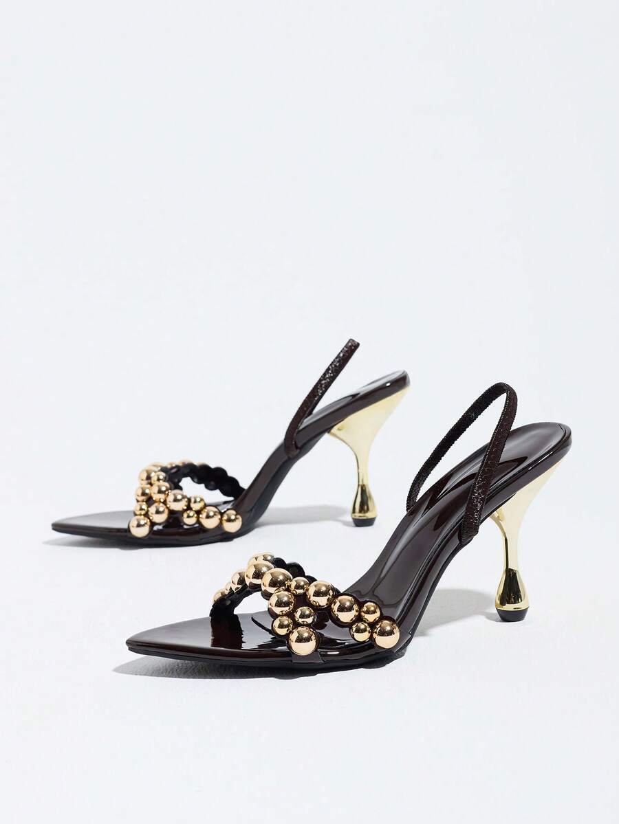 Pointed toe party high heels in gold featuring wavy lace trim, a stiletto heel, and back tie slingback straps.