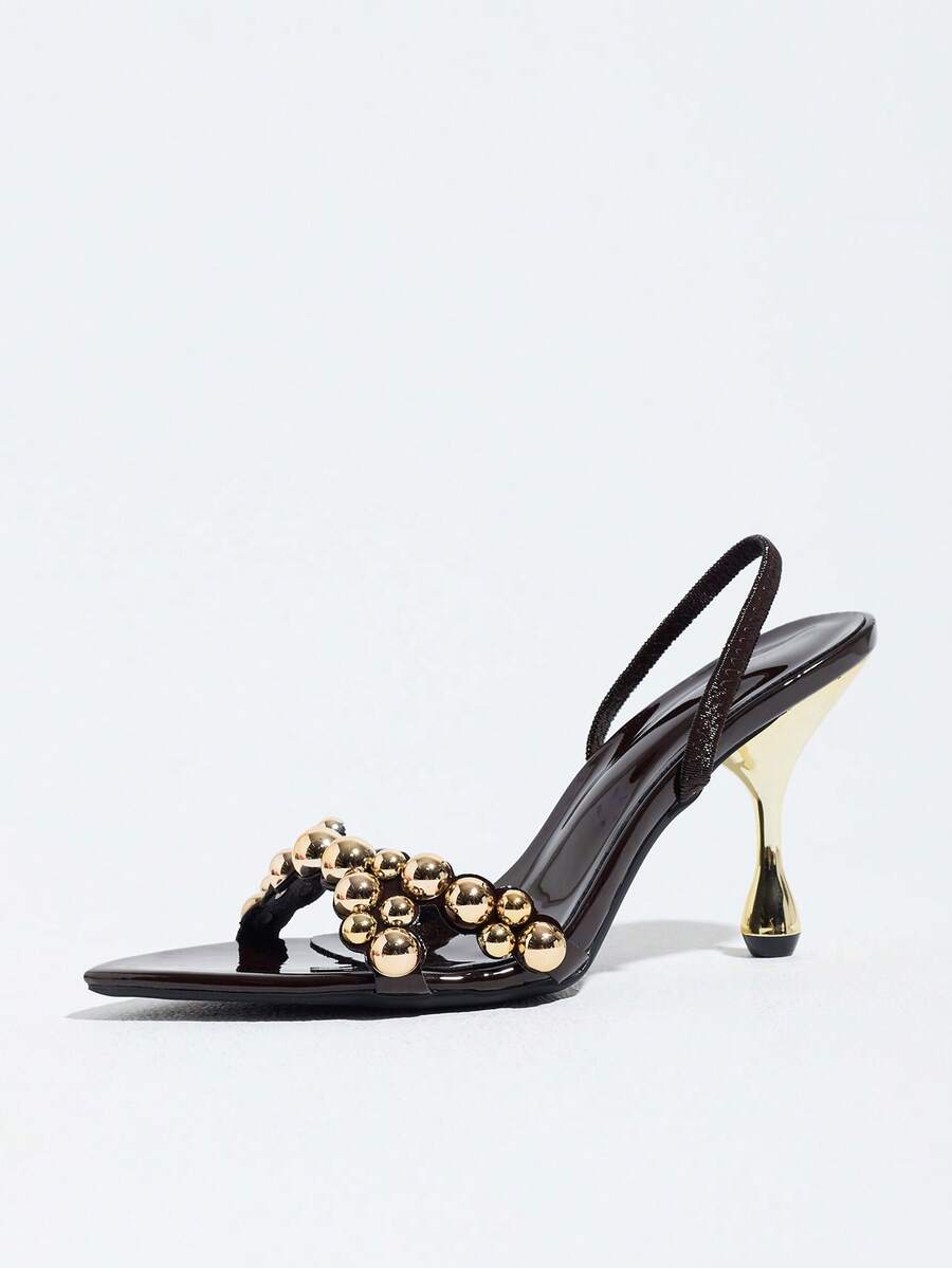 Pointed toe party high heels in gold featuring wavy lace trim, a stiletto heel, and back tie slingback straps.