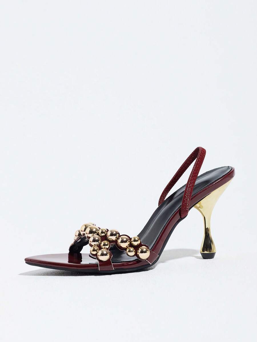 Pointed toe party high heels in gold featuring wavy lace trim, a stiletto heel, and back tie slingback straps.