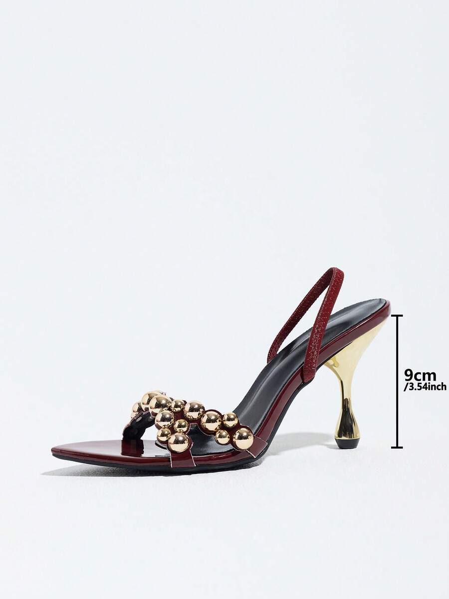 Pointed toe party high heels in gold featuring wavy lace trim, a stiletto heel, and back tie slingback straps.
