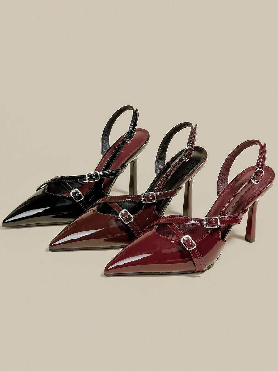 Women's pointed toe kitten heel pumps with adjustable buckle back strap and sleek patent finish.