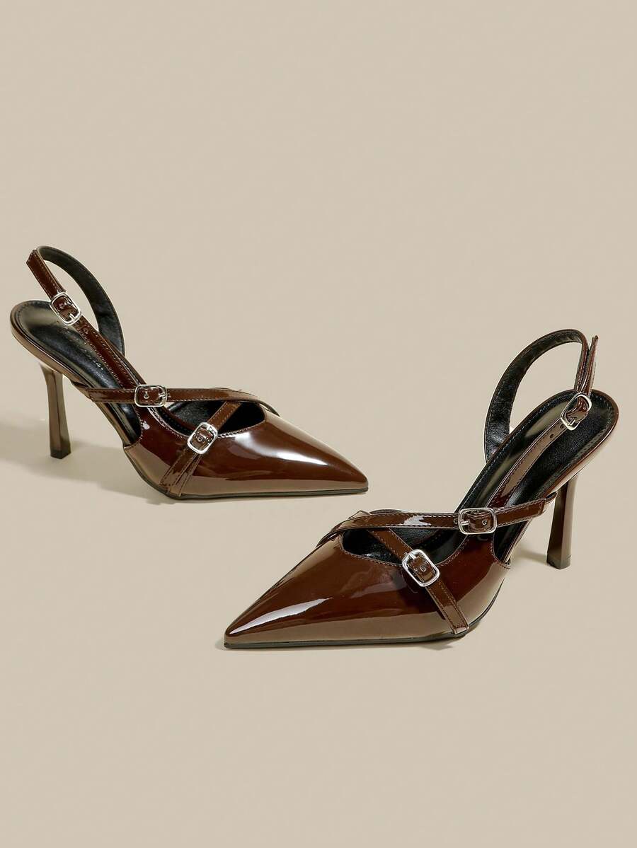 Women's pointed toe kitten heel pumps with adjustable buckle back strap and sleek patent finish.