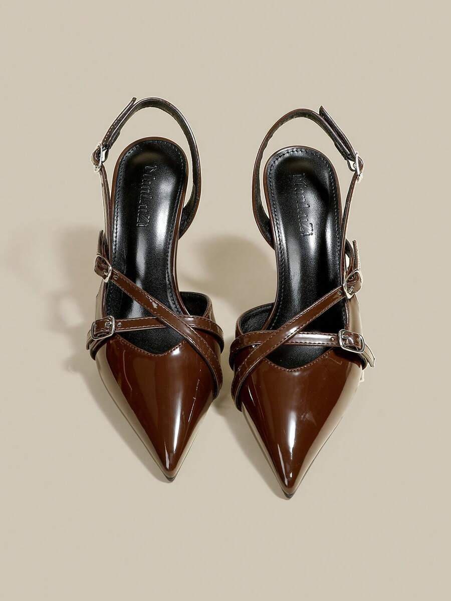 Women's pointed toe kitten heel pumps with adjustable buckle back strap and sleek patent finish.