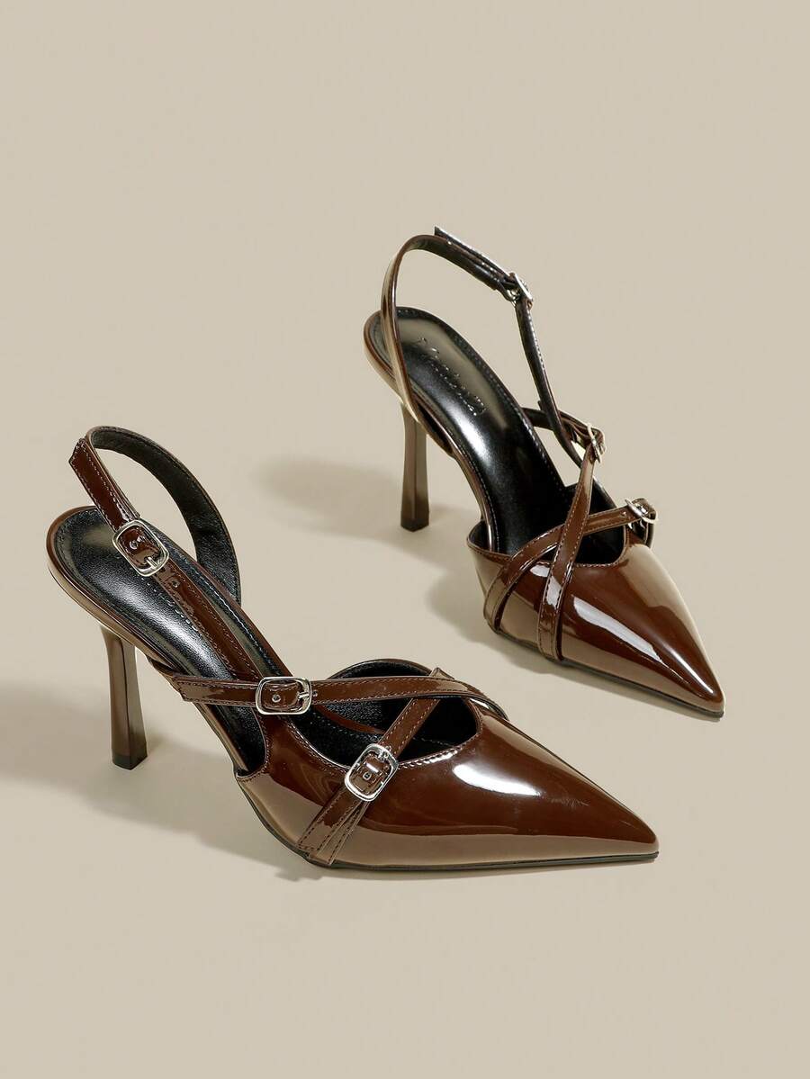 Women's pointed toe kitten heel pumps with adjustable buckle back strap and sleek patent finish.