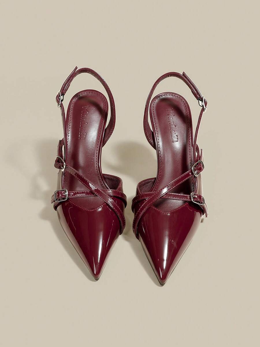 Women's pointed toe kitten heel pumps with adjustable buckle back strap and sleek patent finish.
