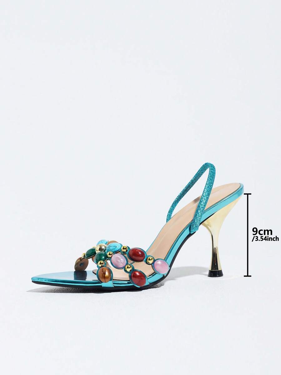 Pointed toe party high heels in gold featuring wavy lace trim, a stiletto heel, and back tie slingback straps.