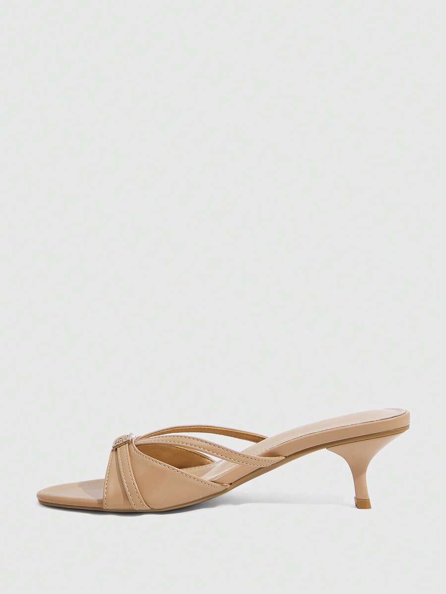 Women's light gold kitten heel slingback sandals featuring an open toe and round buckle strap.
