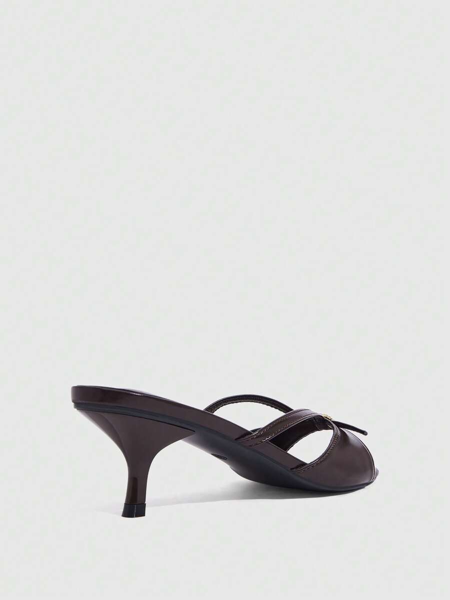 Women's light gold kitten heel slingback sandals featuring an open toe and round buckle strap.