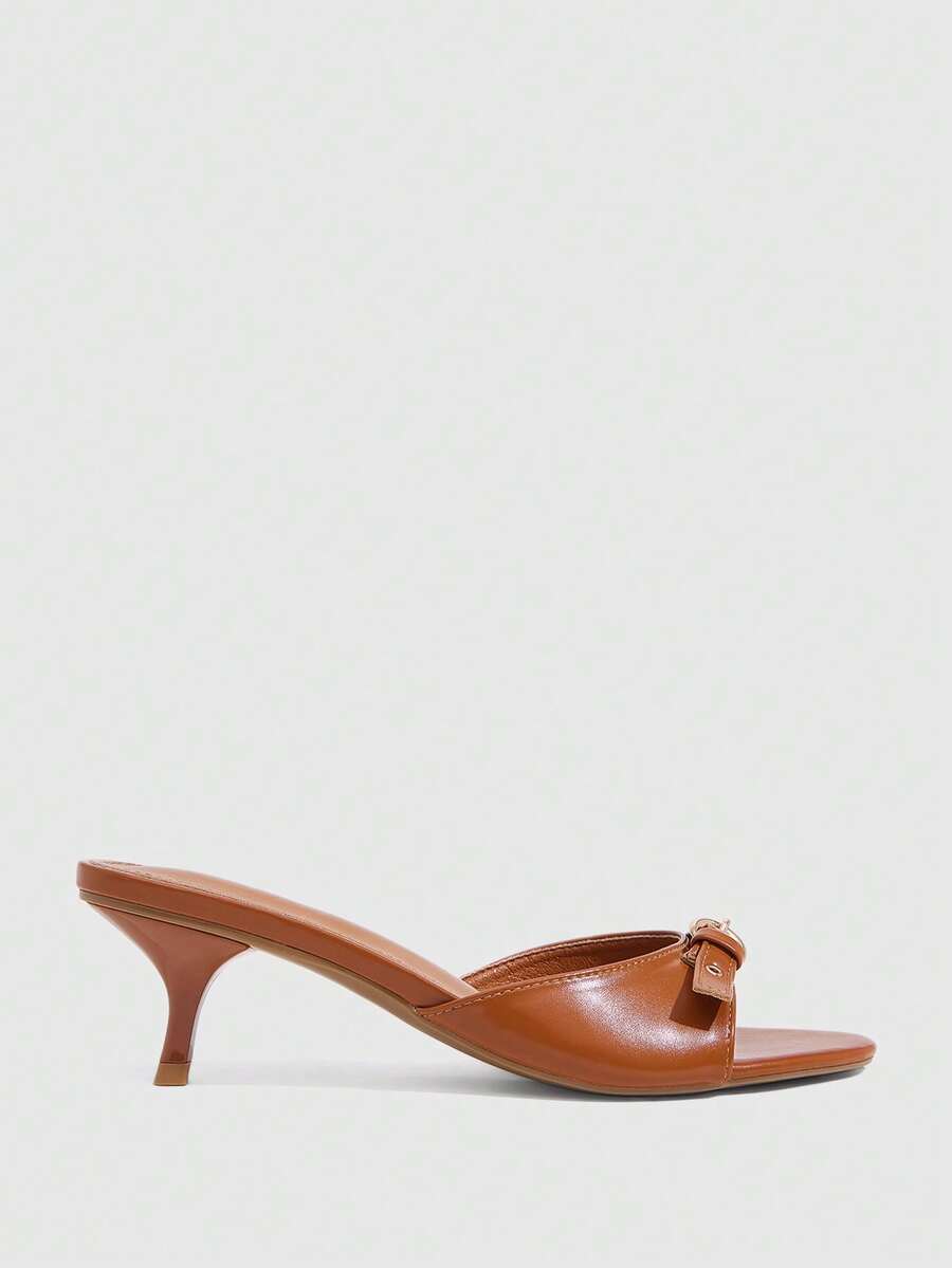 Women's light gold kitten heel slingback sandals featuring an open toe and round buckle strap.