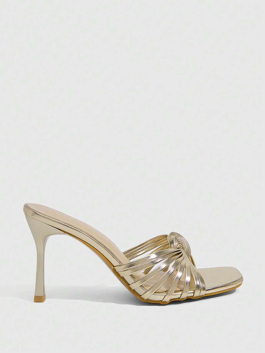 Women's gold open square toe high-heeled sandals featuring a stylish twist strap and stiletto heel.