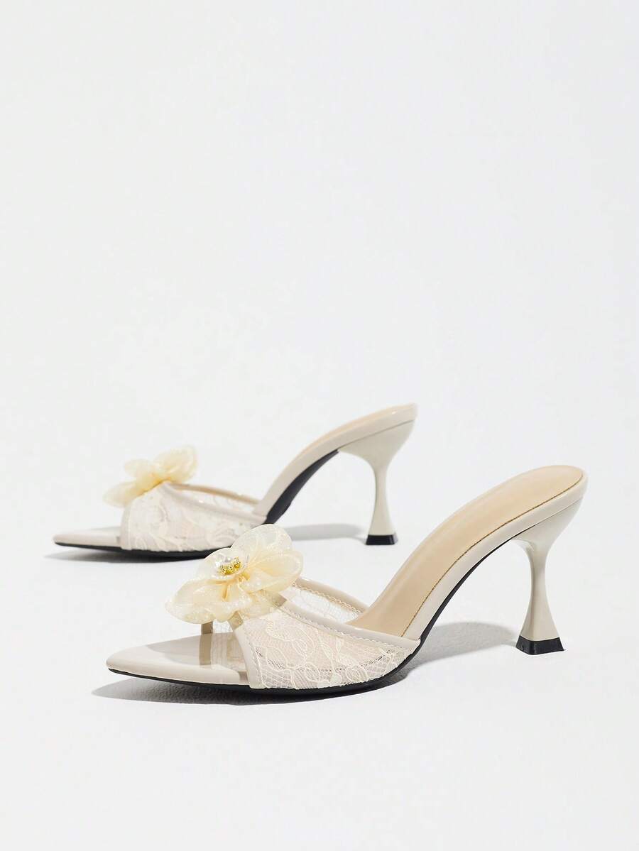 Women's pointed toe high heel mule sandals featuring a sleek slip-on design with elegant lace embroidery detailing