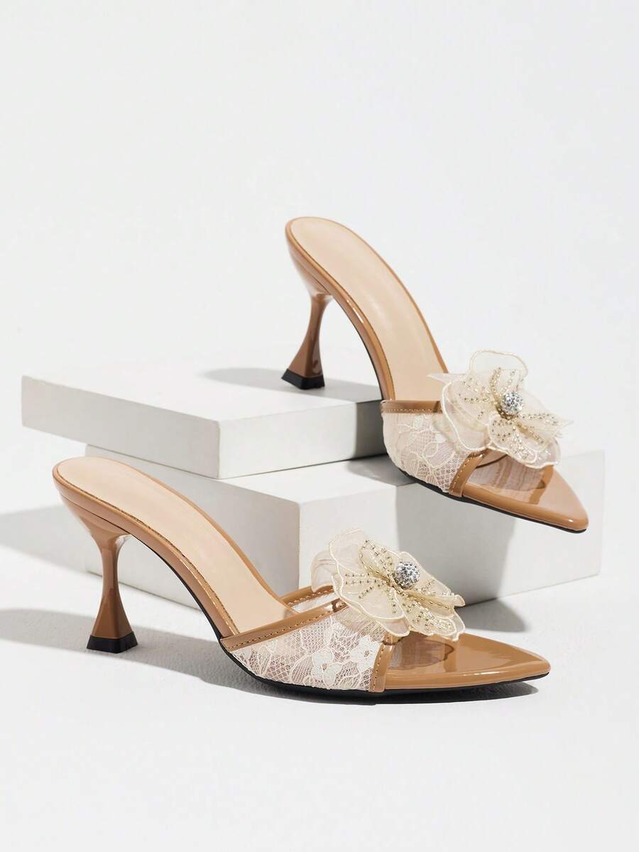 Women's pointed toe high heel mule sandals featuring a sleek slip-on design with elegant lace embroidery detailing