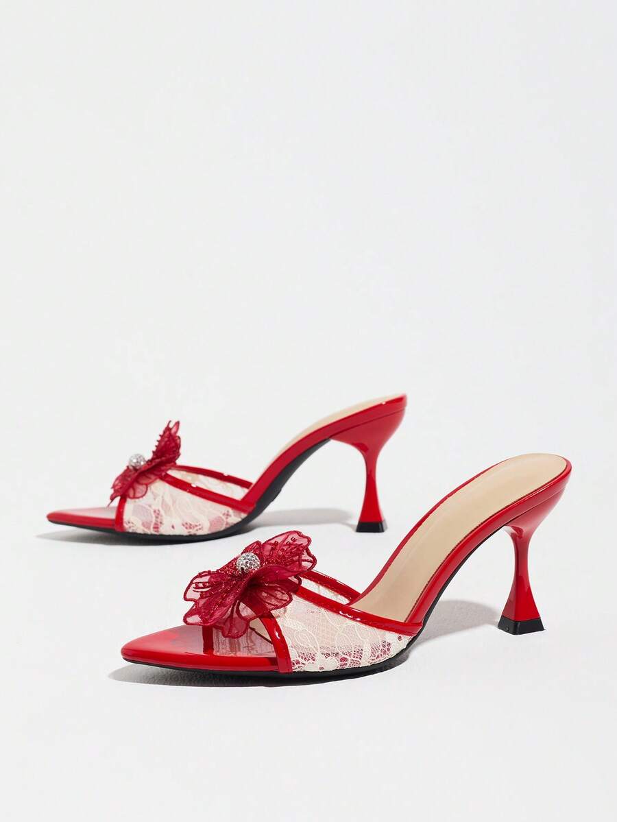 Women's pointed toe high heel mule sandals featuring a sleek slip-on design with elegant lace embroidery detailing