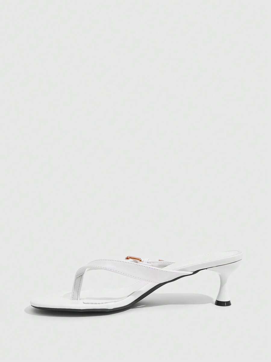 Women's patent leather heeled sandals featuring a toe post strap with metal buckle and mid pyramid heel.