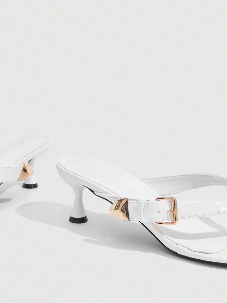 Women's patent leather heeled sandals featuring a toe post strap with metal buckle and mid pyramid heel.