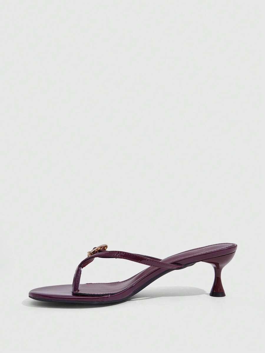Women's slingback heeled sandals featuring a button toe post accent, sleek mid pyramid heel, and smooth faux leather finish.