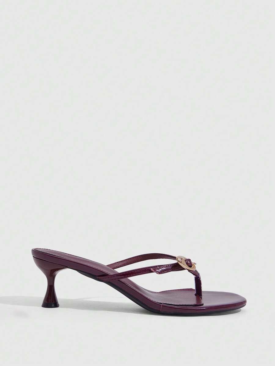 Women's slingback heeled sandals featuring a button toe post accent, sleek mid pyramid heel, and smooth faux leather finish.
