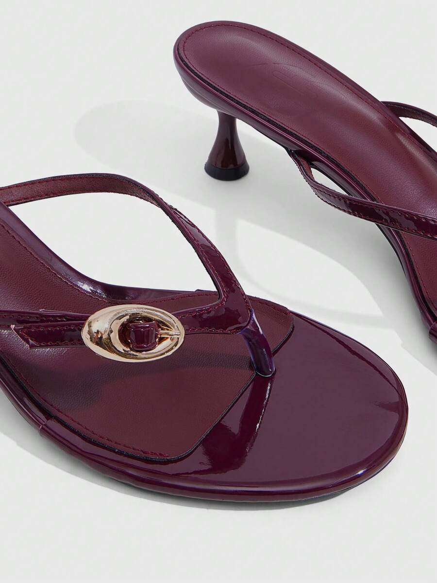 Women's slingback heeled sandals featuring a button toe post accent, sleek mid pyramid heel, and smooth faux leather finish.