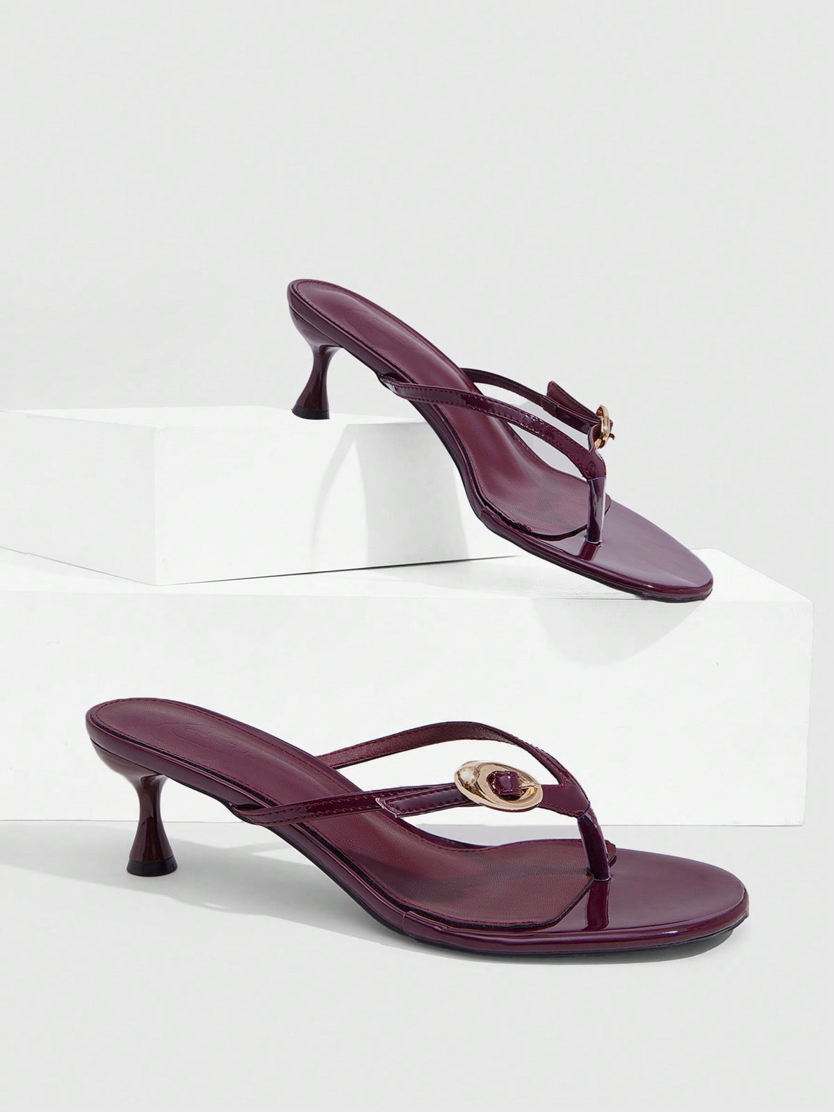 Women's slingback heeled sandals featuring a button toe post accent, sleek mid pyramid heel, and smooth faux leather finish.