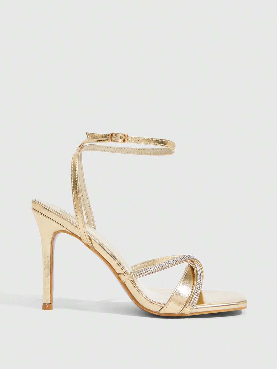 Women's pointed peep toe high heel stilettos featuring cross ankle strap with buckle in black PU leather.