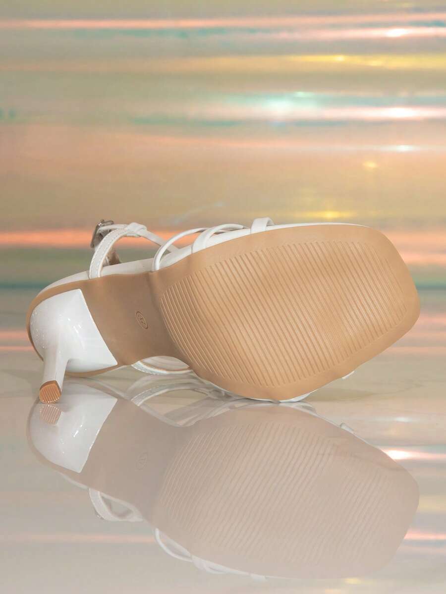 Women's stiletto high heel thong sandals featuring a T-strap toe loop design and ankle buckle strap