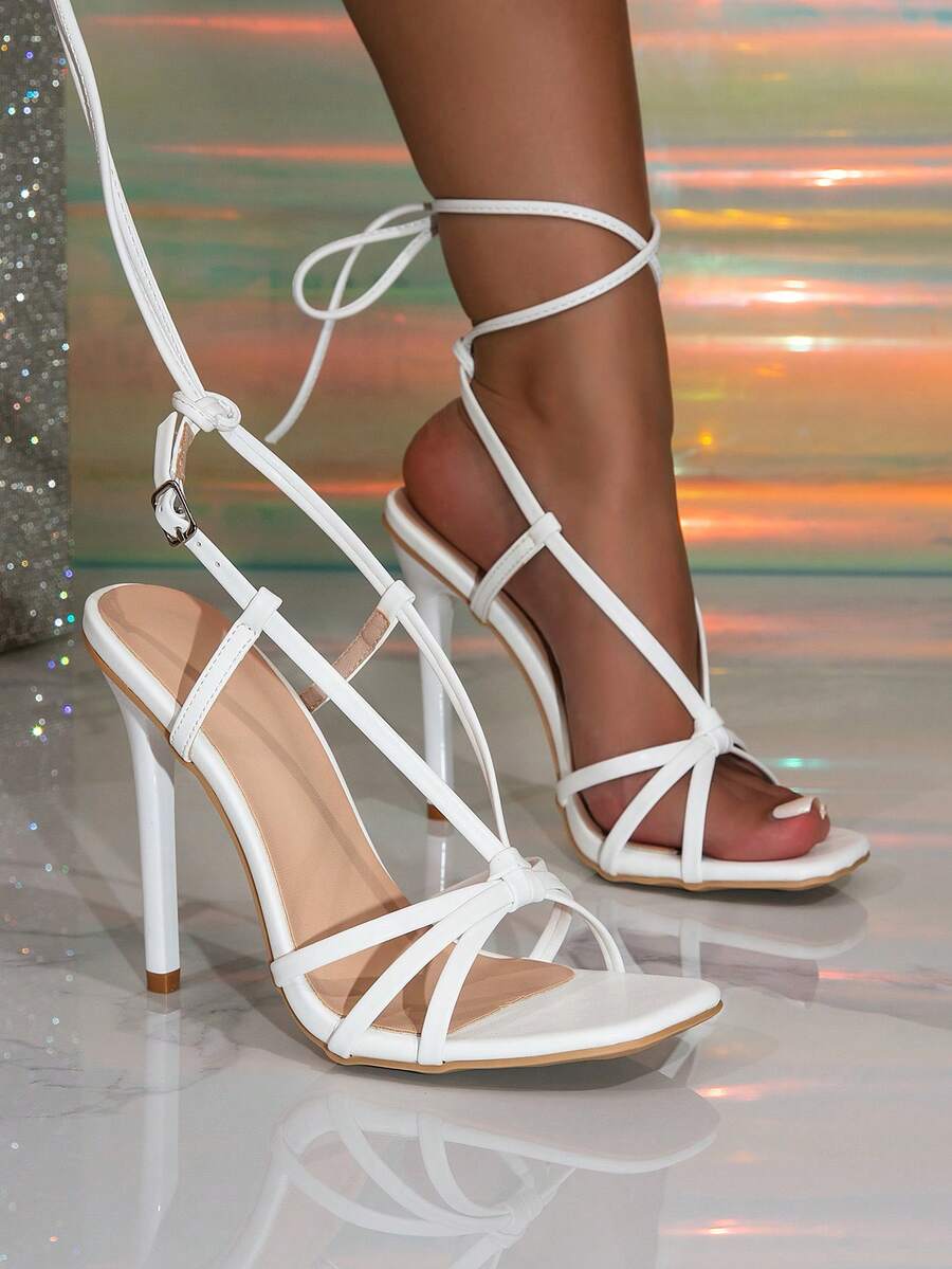 Women's stiletto high heel thong sandals featuring a T-strap toe loop design and ankle buckle strap