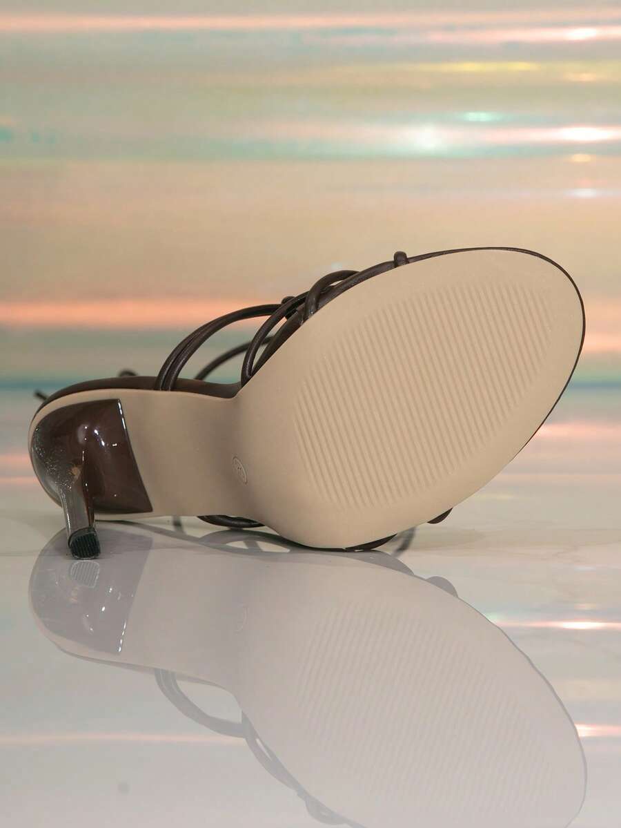 Women's stiletto high heel thong sandals featuring a T-strap toe loop design and ankle buckle strap
